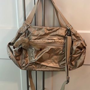 Gently used KIPLING bag in gold.